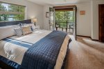 Primary bedroom upstairs with king bed, luxury linens and private lake views deck.